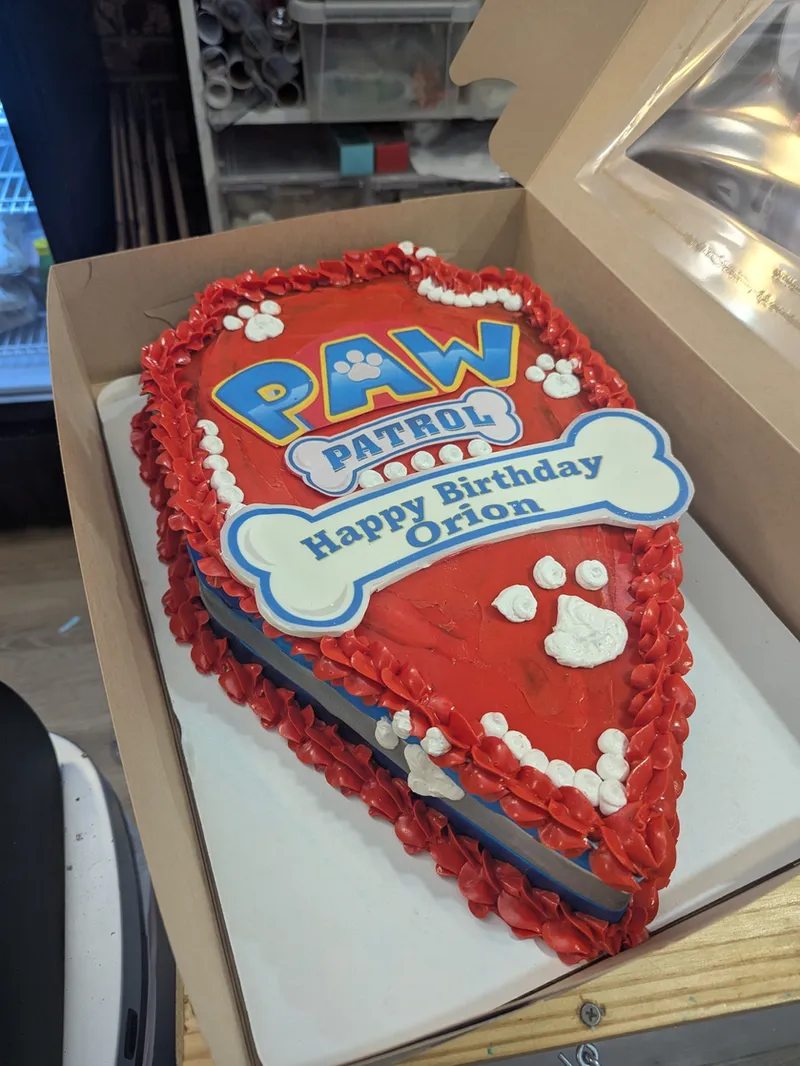 Shield-shaped red Paw Patrol birthday cake