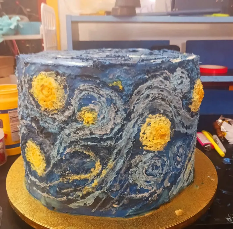 Textured buttercream cake painted in the swirls of Van Gogh's Starry Night