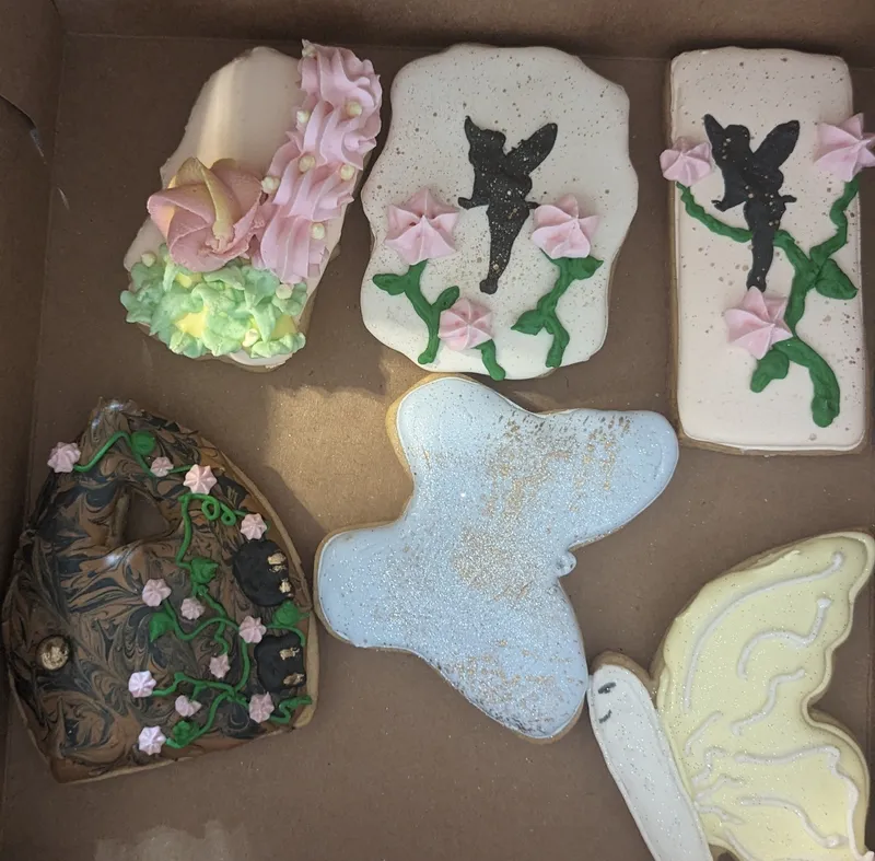 Cookies with fairy silhouettes, butterflies and pink blossoms