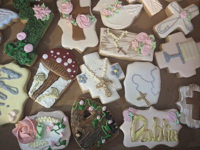Royal-iced first communion cookies with crosses, doves, flowers and a name plaque