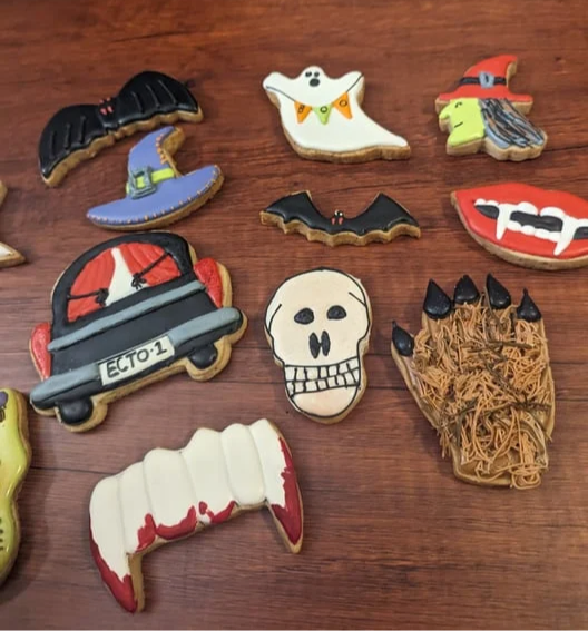 Thirteen Halloween sugar cookies: witch hats, ghost, bats, skull, hearse, vampire smile and more